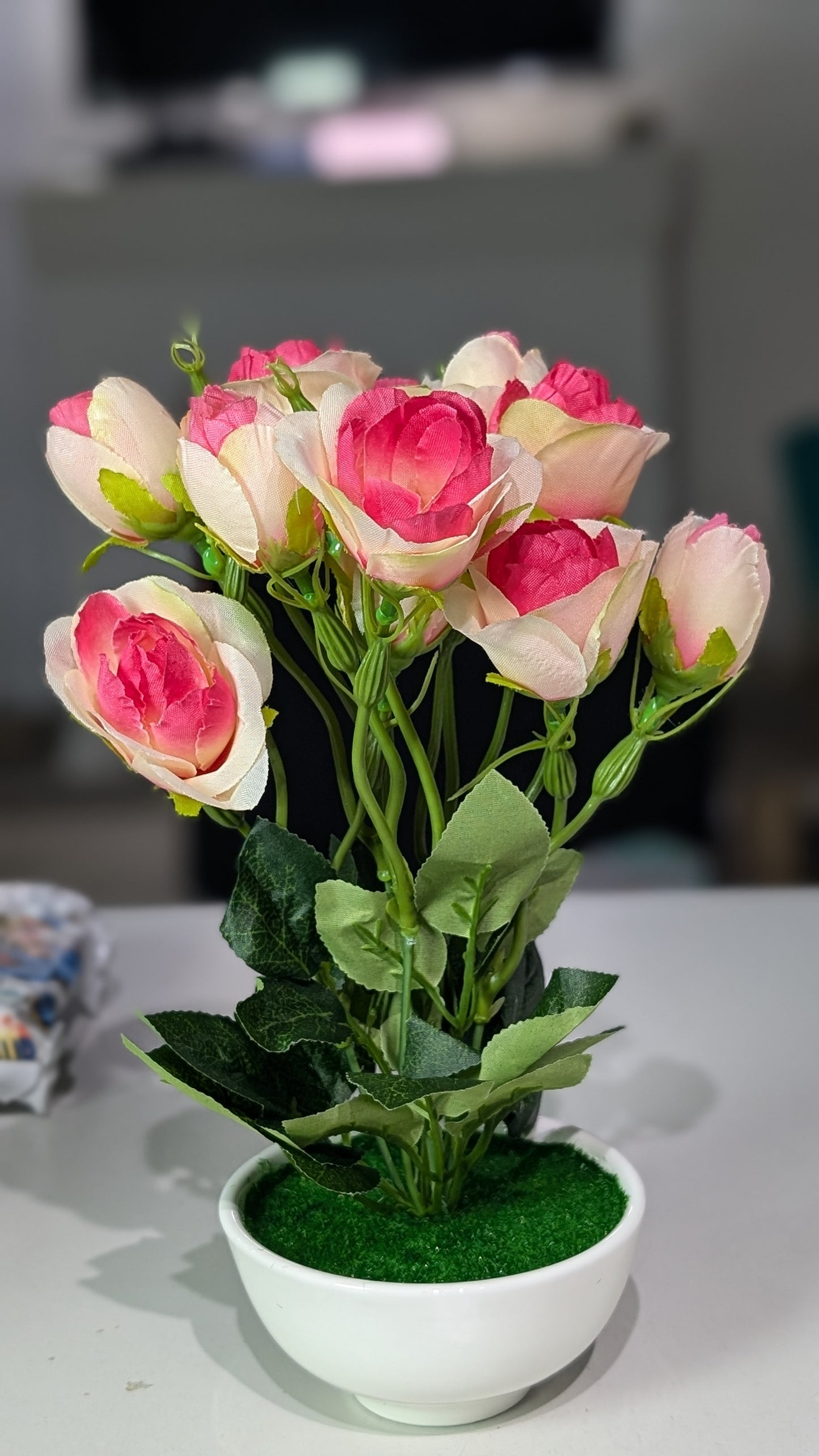 Pink rose stalks with vase